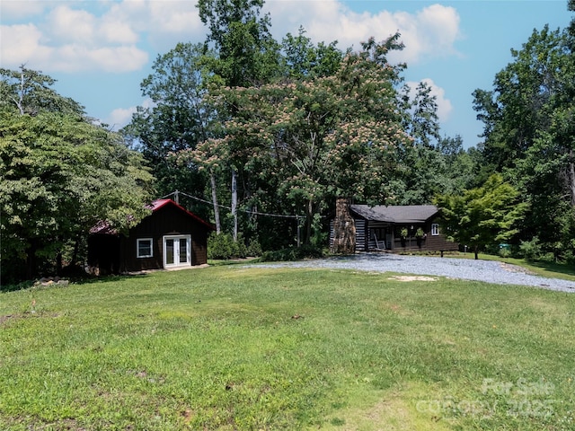 225 Wilderness Rd, Tryon, NC 28782 - view of green lawn featuring french doors and a wooded view