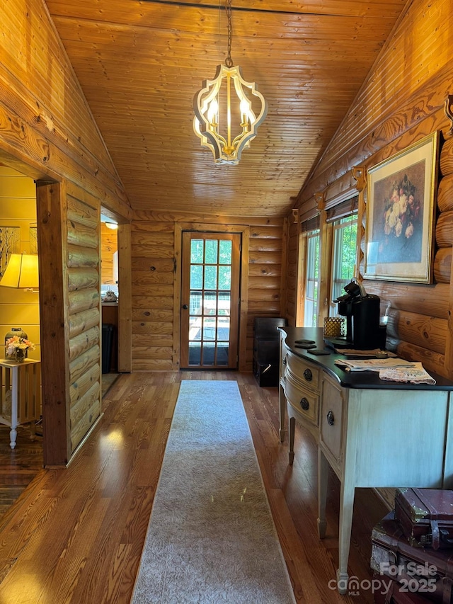 19 Timbers Edge Ln Unit 23, Fairview, NC 28730 - interior space featuring vaulted ceiling, a chandelier, dark wood-style floors, wood ceiling, and log walls