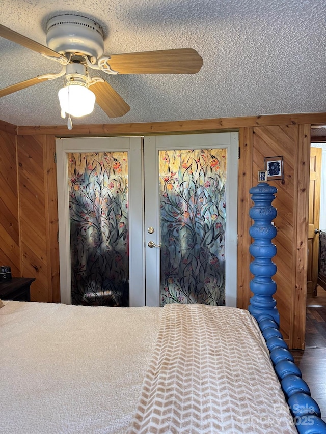 19 Timbers Edge Ln Unit 23, Fairview, NC 28730 - bedroom featuring a textured ceiling, wood walls, and a ceiling fan