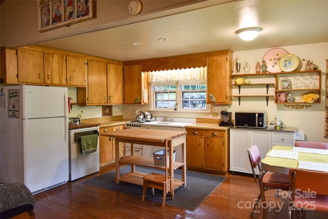3435 Conleys Creek Rd, Whittier, NC 28789 - kitchen with freestanding refrigerator, stove, dark wood-type flooring, brown cabinets, and open shelves