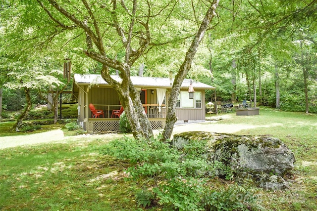 3435 Conleys Creek Rd, Whittier, NC 28789 - view of front of house featuring board and batten siding, covered porch, a forest view, and a front yard