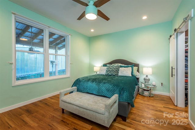 84 W St, Weaverville, NC 28787 - bedroom featuring a barn door, wood finished floors, recessed lighting, and ceiling fan