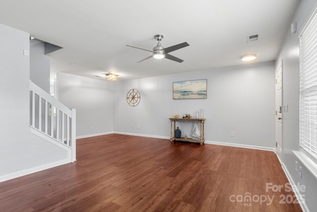 11023 Kinston Ridge Pl, Charlotte, NC 28273 - unfurnished living room with ceiling fan, wood finished floors, and stairway