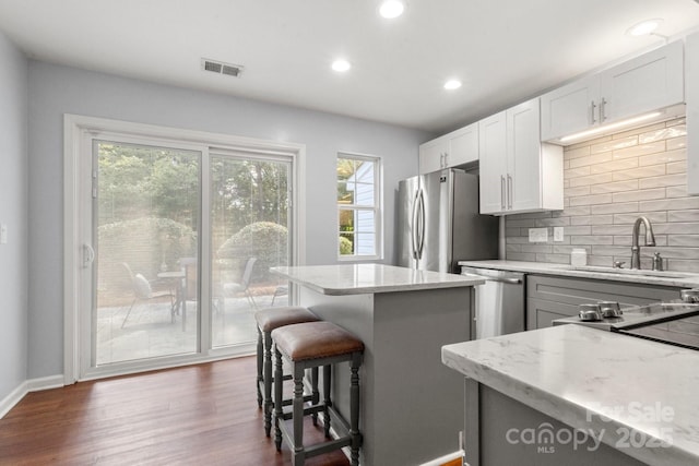 11023 Kinston Ridge Pl, Charlotte, NC 28273 - kitchen with tasteful backsplash, light stone countertops, stainless steel appliances, dark wood finished floors, and recessed lighting