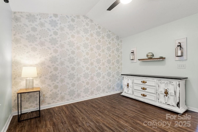 11023 Kinston Ridge Pl, Charlotte, NC 28273 - unfurnished bedroom with vaulted ceiling, dark wood-type flooring, wallpapered walls, and a ceiling fan