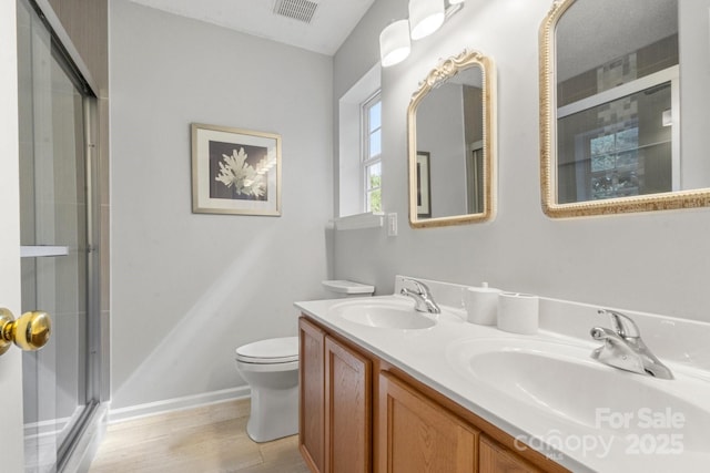 11023 Kinston Ridge Pl, Charlotte, NC 28273 - full bathroom with a shower with shower door, double vanity, and wood finished floors