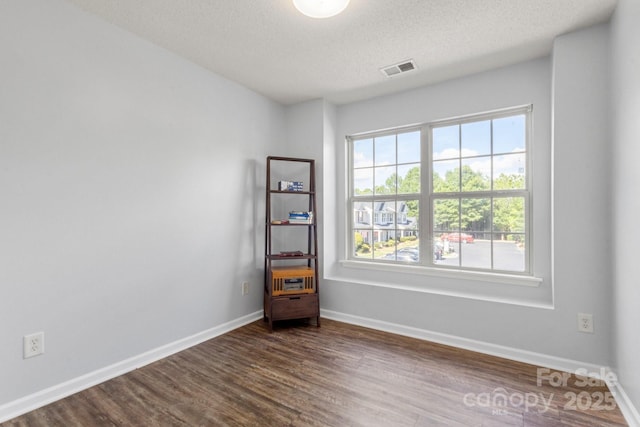 11023 Kinston Ridge Pl, Charlotte, NC 28273 - empty room featuring dark wood-style flooring and a textured ceiling