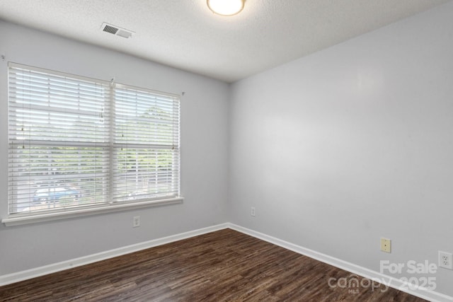 11023 Kinston Ridge Pl, Charlotte, NC 28273 - spare room with plenty of natural light, dark wood-style floors, and a textured ceiling