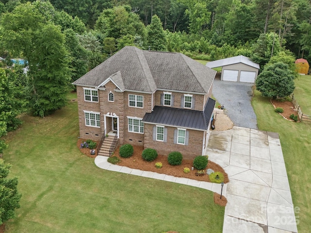 9450 Surface Hill Rd, Mint Hill, NC 28227 - colonial-style house with brick siding, a garage, an outbuilding, a standing seam roof, and a front lawn