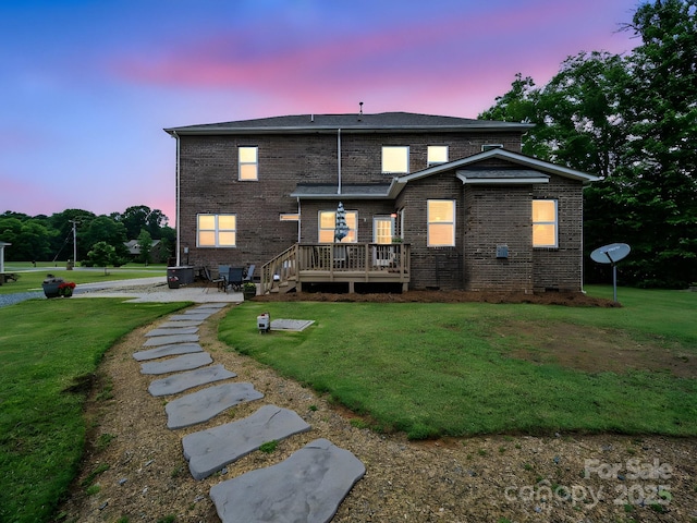 9450 Surface Hill Rd, Mint Hill, NC 28227 - back of property at dusk featuring a deck, a patio, and a lawn