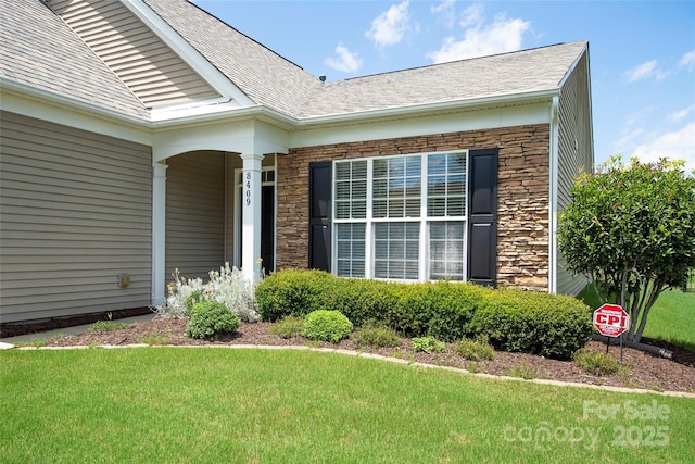 8409 Darcy Hopkins Dr, Charlotte, NC 28277 - entrance to property with stone siding, a lawn, and roof with shingles