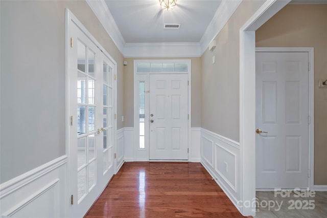 8409 Darcy Hopkins Dr, Charlotte, NC 28277 - foyer featuring a decorative wall, wainscoting, crown molding, and wood finished floors