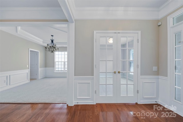 8409 Darcy Hopkins Dr, Charlotte, NC 28277 - doorway with french doors, wood finished floors, a chandelier, a wainscoted wall, and ornamental molding