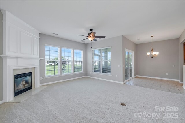 8409 Darcy Hopkins Dr, Charlotte, NC 28277 - unfurnished living room with a chandelier, ceiling fan, light colored carpet, a premium fireplace, and light tile patterned floors