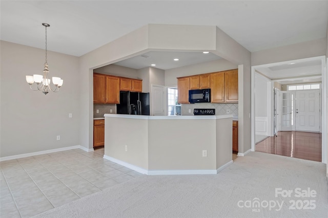 8409 Darcy Hopkins Dr, Charlotte, NC 28277 - kitchen featuring black appliances, a chandelier, brown cabinetry, backsplash, and recessed lighting
