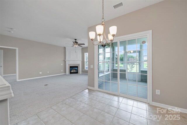 8409 Darcy Hopkins Dr, Charlotte, NC 28277 - carpeted spare room with ceiling fan, tile patterned flooring, a fireplace, and a chandelier