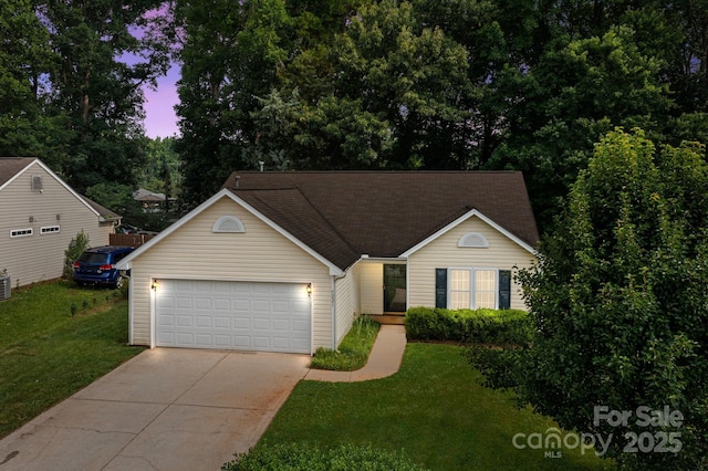 5221 Javitz Rd, Charlotte, NC 28216 - view of front of home with concrete driveway, a garage, and a front lawn