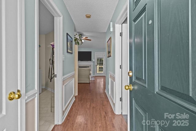 5221 Javitz Rd, Charlotte, NC 28216 - foyer entrance featuring ceiling fan, a textured ceiling, and wood finished floors