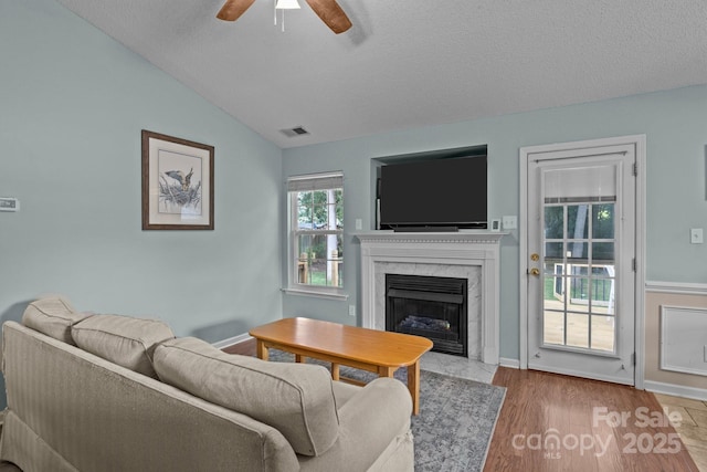 5221 Javitz Rd, Charlotte, NC 28216 - living room featuring a ceiling fan, a fireplace, lofted ceiling, and wood finished floors