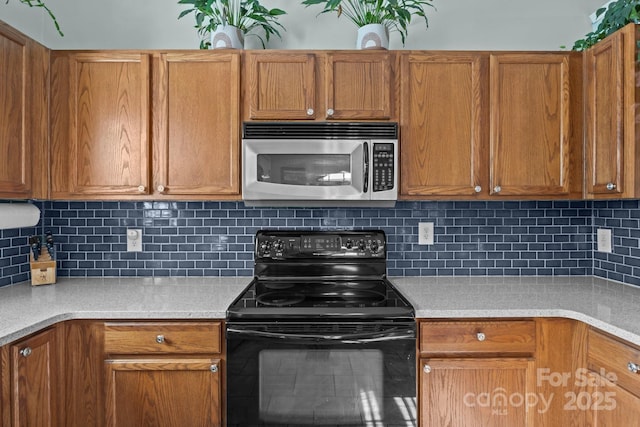 5221 Javitz Rd, Charlotte, NC 28216 - kitchen featuring stainless steel microwave, electric range, light countertops, and backsplash
