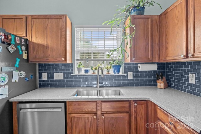 5221 Javitz Rd, Charlotte, NC 28216 - kitchen featuring appliances with stainless steel finishes, light countertops, decorative backsplash, and brown cabinetry
