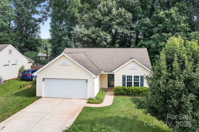 5221 Javitz Rd, Charlotte, NC 28216 - view of front facade featuring driveway, a garage, and a front lawn