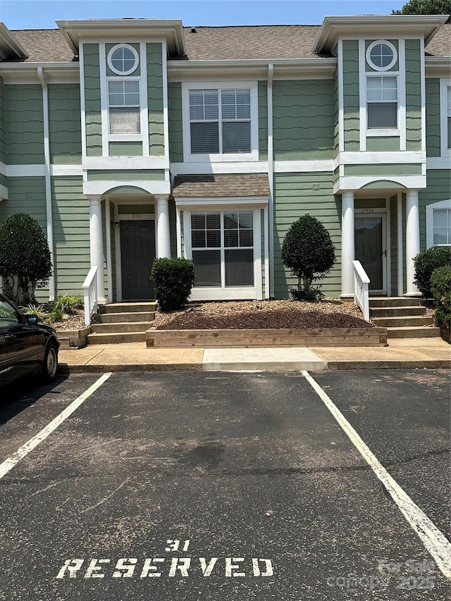 17431 Tuscany Ln, Cornelius, NC 28031 - view of property featuring uncovered parking and roof with shingles
