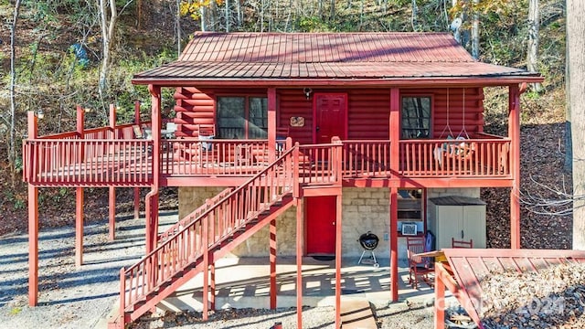 306 Forget Me Not Ln, Whittier, NC 28789 - log-style house with log exterior, a metal roof, stairs, and covered porch