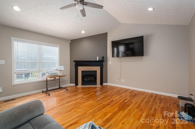 104 Nottingham Dr, Maiden, NC 28650 - living room featuring light wood-style floors, ceiling fan, a fireplace with flush hearth, a textured ceiling, and recessed lighting