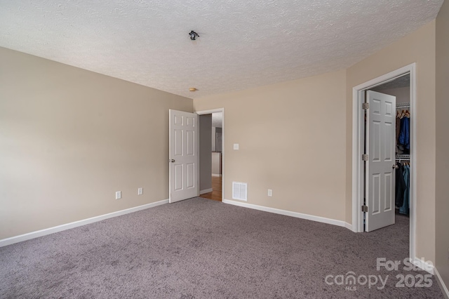 104 Nottingham Dr, Maiden, NC 28650 - unfurnished bedroom featuring carpet flooring, a spacious closet, a textured ceiling, and a closet