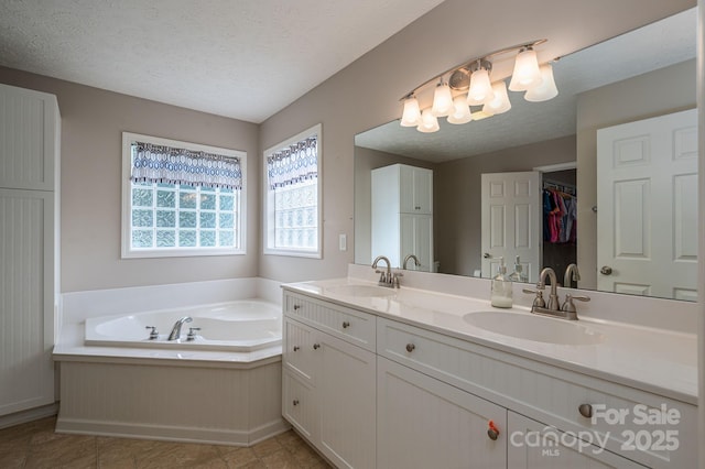 104 Nottingham Dr, Maiden, NC 28650 - bathroom featuring double vanity, a bath, a textured ceiling, a chandelier, and tile patterned flooring