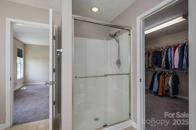 104 Nottingham Dr, Maiden, NC 28650 - bathroom featuring a textured ceiling, a shower stall, and a spacious closet