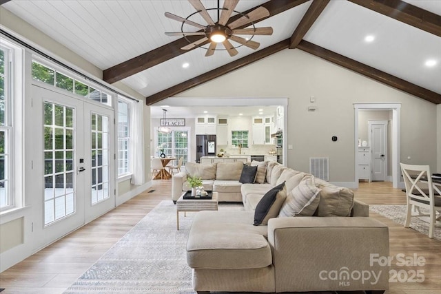 402 Wildlife Rd, Troutman, NC 28166 - living room featuring french doors, plenty of natural light, beam ceiling, a ceiling fan, and light wood-style flooring