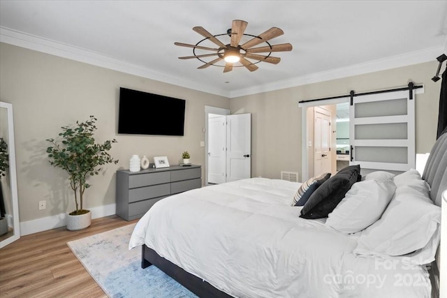402 Wildlife Rd, Troutman, NC 28166 - bedroom featuring a barn door, crown molding, light wood-style flooring, and ceiling fan