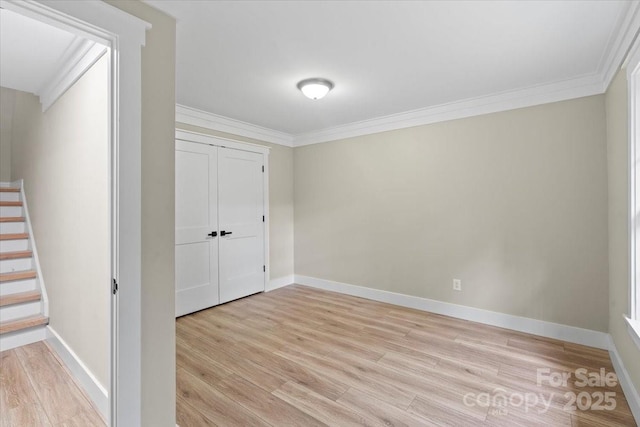 402 Wildlife Rd, Troutman, NC 28166 - unfurnished bedroom with light wood-type flooring, ornamental molding, and a closet
