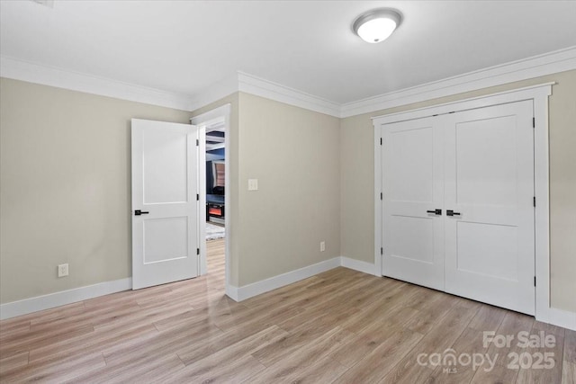 402 Wildlife Rd, Troutman, NC 28166 - unfurnished bedroom featuring crown molding, light wood finished floors, and a closet