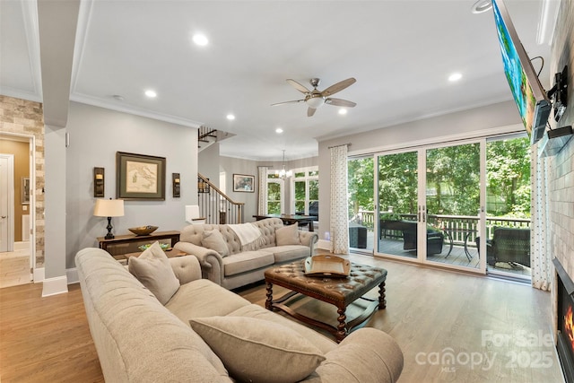 10007 Hillspring Dr, Huntersville, NC 28078 - living room with stairs, a ceiling fan, light wood-style floors, ornamental molding, and recessed lighting
