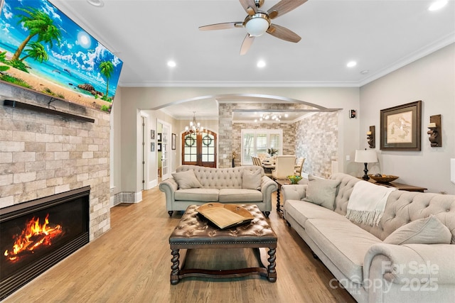 10007 Hillspring Dr, Huntersville, NC 28078 - living area featuring arched walkways, a chandelier, crown molding, ceiling fan, and light wood-style floors