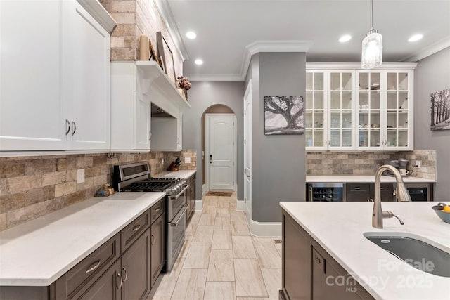 10007 Hillspring Dr, Huntersville, NC 28078 - kitchen featuring range with two ovens, crown molding, wine cooler, white cabinetry, and light countertops