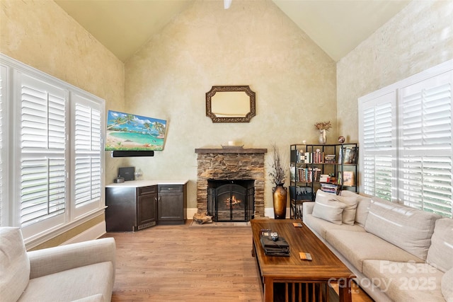 10007 Hillspring Dr, Huntersville, NC 28078 - living area featuring light wood-style flooring, plenty of natural light, high vaulted ceiling, and a fireplace