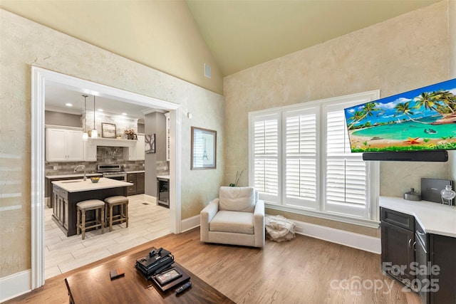 10007 Hillspring Dr, Huntersville, NC 28078 - living room featuring light wood-type flooring, lofted ceiling, and wine cooler