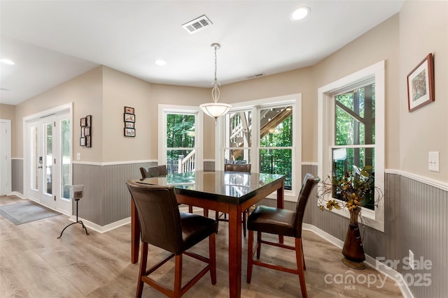 10007 Hillspring Dr, Huntersville, NC 28078 - dining space featuring wainscoting, light wood-style flooring, and healthy amount of natural light