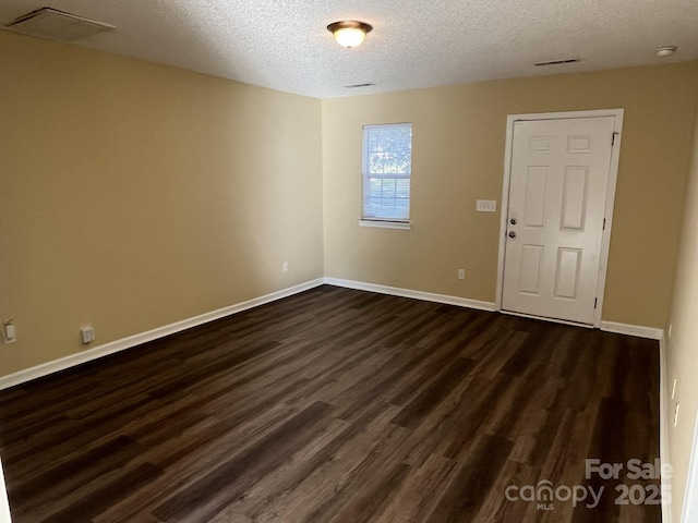 6130 Sid Crane Dr, Charlotte, NC 28216 - spare room featuring a textured ceiling and dark wood finished floors