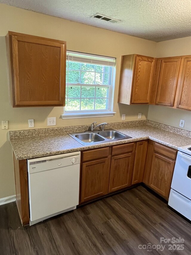 6130 Sid Crane Dr, Charlotte, NC 28216 - kitchen with white appliances, dark wood finished floors, a textured ceiling, light countertops, and brown cabinets