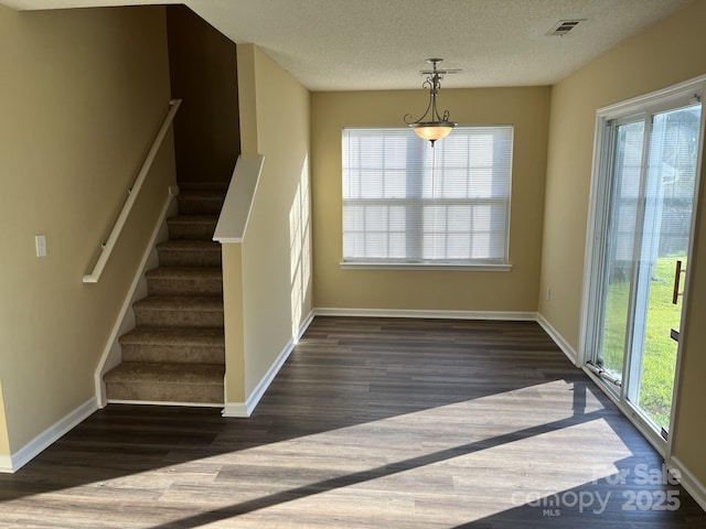6130 Sid Crane Dr, Charlotte, NC 28216 - stairs with wood finished floors, plenty of natural light, and a textured ceiling