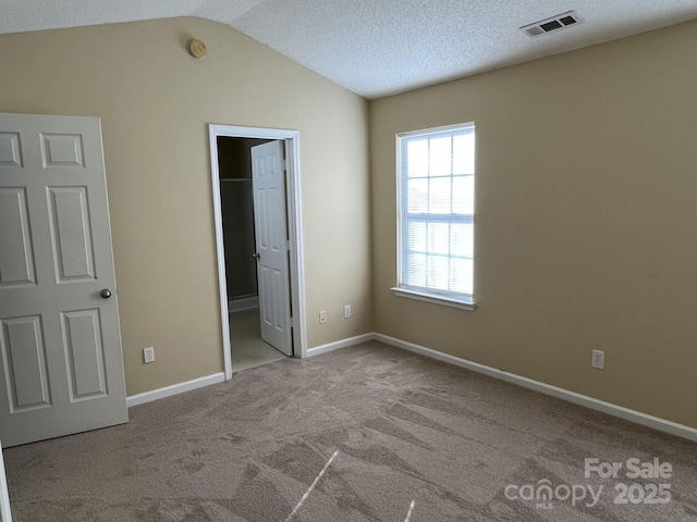 6130 Sid Crane Dr, Charlotte, NC 28216 - unfurnished bedroom featuring carpet and vaulted ceiling