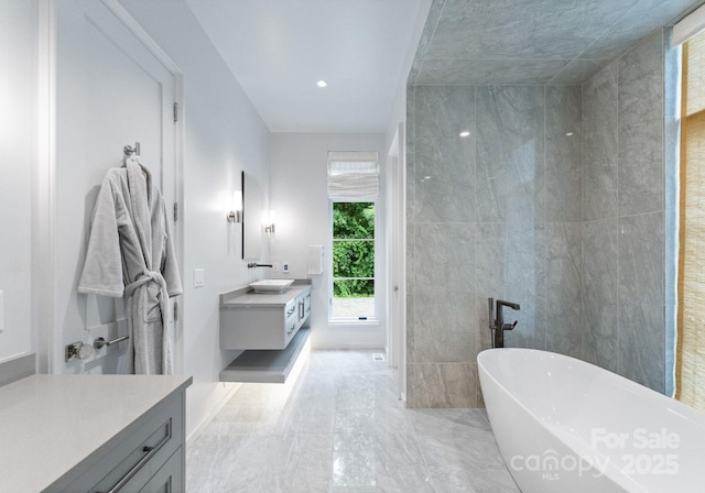 2837 Kenwood Sharon Ln, Charlotte, NC 28211 - full bath with vanity, a soaking tub, recessed lighting, and tile walls
