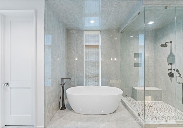 2837 Kenwood Sharon Ln, Charlotte, NC 28211 - full bathroom with a soaking tub, a shower stall, and tile walls