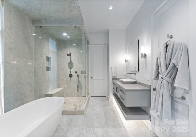 2837 Kenwood Sharon Ln, Charlotte, NC 28211 - full bath with a freestanding tub, a shower stall, double vanity, and recessed lighting