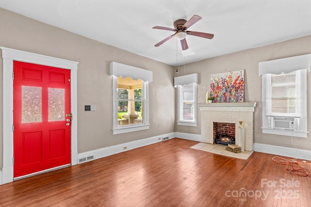 524 W Horah St, Salisbury, NC 28144 - unfurnished living room featuring wood finished floors, cooling unit, a brick fireplace, and a ceiling fan